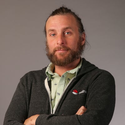 Tim Hildred stands with arms crossed. 