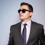 Kelly Albrecht in a suit and sun glasses.